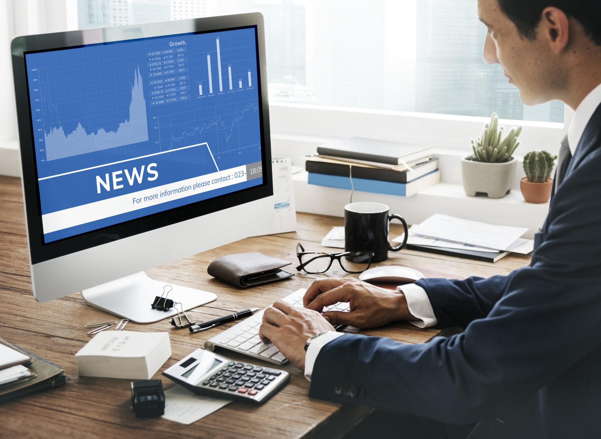 man looking stock market news computer scaled